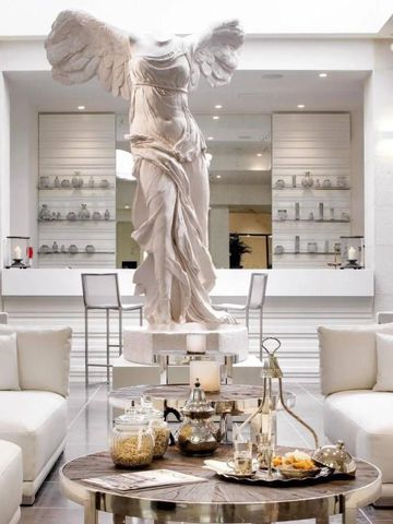 Luxuriöse Lobby mit beeindruckender Statue und einladendem Lounge-Bereich