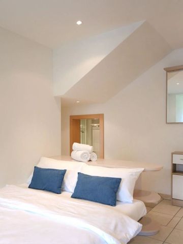 Helles Schlafzimmer mit Dachschräge und moderner Dekoration