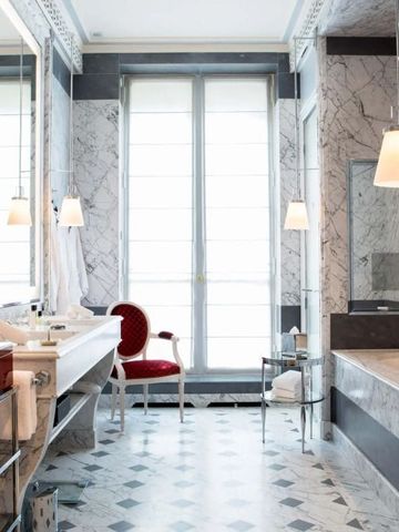 Großes Badezimmer mit Marmordekor und opulenter Ausstattung