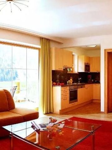 Wohnbereich mit moderner Küche und großen Fenstern