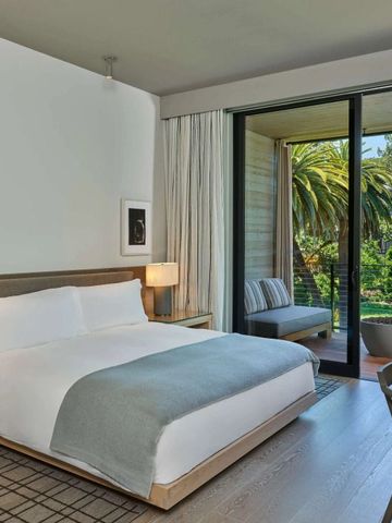 Gemütliches Hotelzimmer mit Balkon und Blick auf den gepflegten Garten.