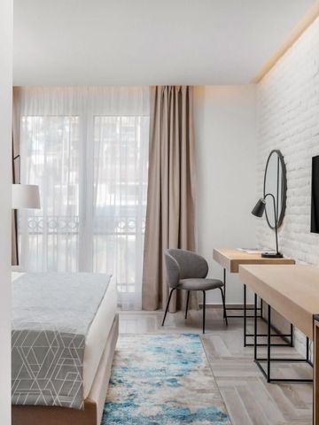 Modern eingerichtetes Hotelzimmer mit Schreibtisch und großem Fenster