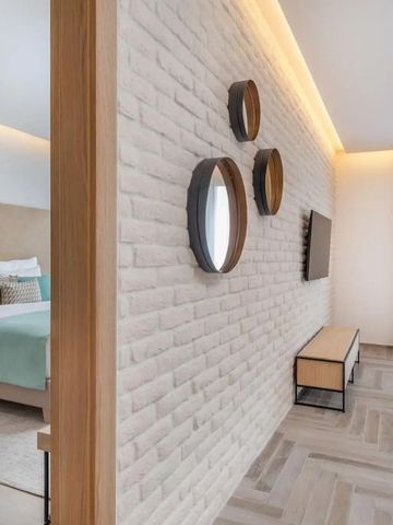 Modernes Hotelzimmer mit stilvoller Backsteinwand und dekorativen Elementen.