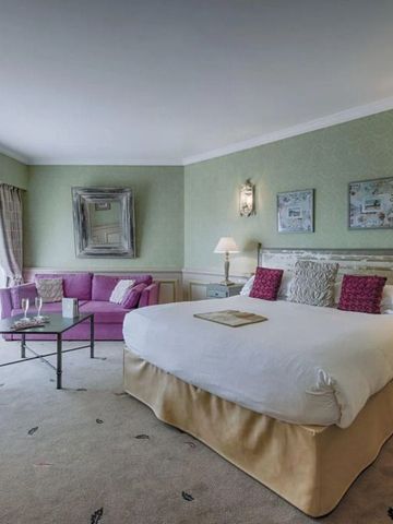 Geräumiges Hotelzimmer mit Kingsize-Bett und eleganter Dekoration