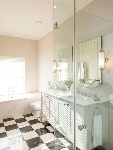 Modernes Badezimmer mit Glasdusche und Doppelwaschbecken.