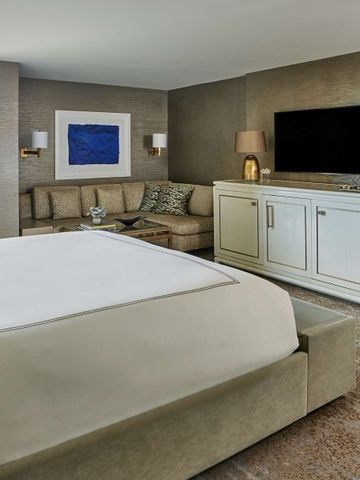 Zimmer mit modernem TV und gemütlichem Sofa im Hotel L'Ermitage Beverly Hills.