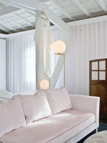 Helles Zimmer mit rosafarbenem Sofa und moderner Einrichtung