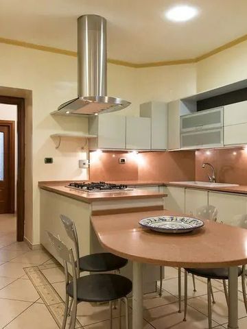 Moderne Küche in warmen Tönen mit eingebautem Herd und Lüftungsabzug