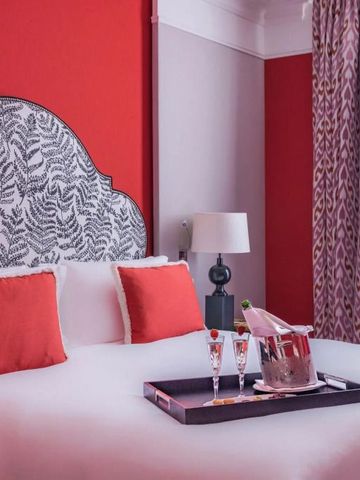 Luxuriöses Hotelzimmer mit rotem Akzent und Champagner-Service