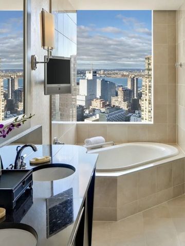 Modernes Badezimmer mit Stadtblick und eleganter Einrichtung.