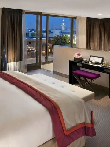 Elegantes Hotelzimmer mit abendlicher Beleuchtung und Stadtblick