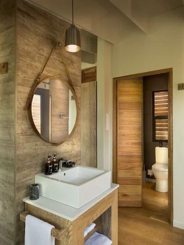 Modern eingerichtetes Badezimmer mit Holz- und Natursteinakzenten