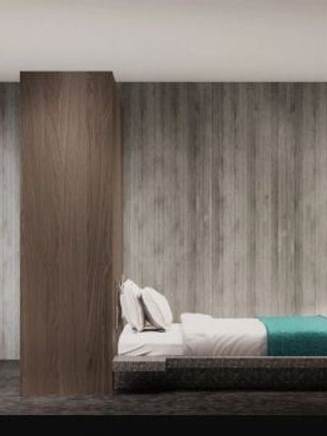 Minimalistisch eingerichtetes Hotelzimmer mit modernem Holzwanddesign und gemütlichem Bett.