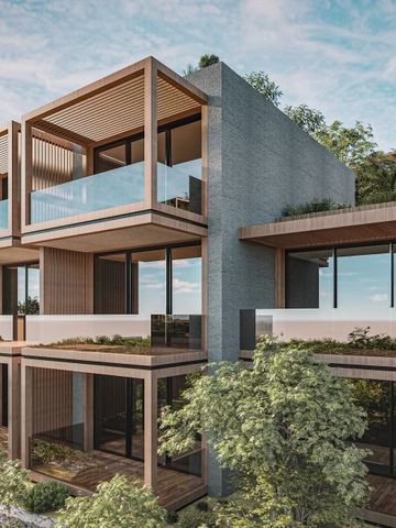 Moderne Architektur mit großen Glasflächen und umliegender grüner Vegetation.