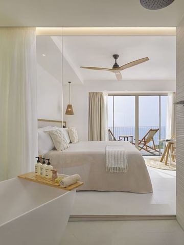 Luxuriöses Hotelzimmer mit freistehender Badewanne und Meerblick