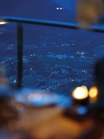 Blick auf das nächtliche Tal von einem Restaurant mit Kerzenlicht