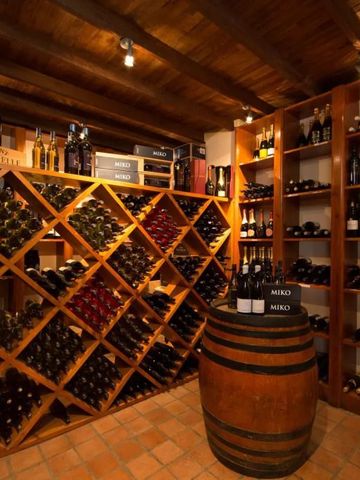 Weinkeller mit Holzregalen und einer Vielzahl von Weinflaschen im Hotelmont Rochelle