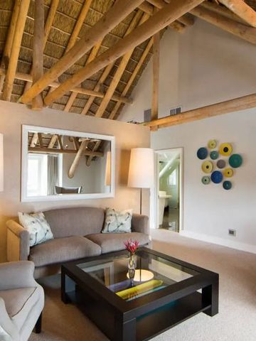 Gemütliches Wohnzimmer mit Holzbalkendecke und eleganter Einrichtung im Hotel