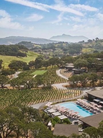 Panoramablick auf Weinberge und Poollandschaft in hügeliger Landschaft.