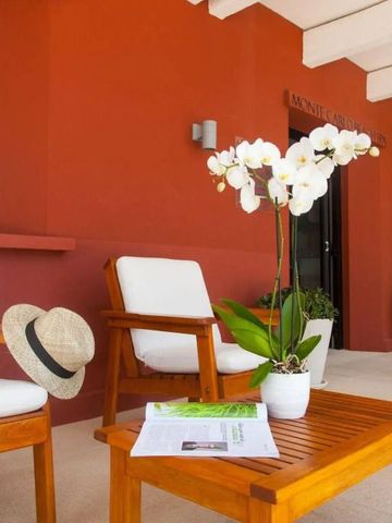 Terrasse mit Holzstühlen und Tisch mit einer Orchidee