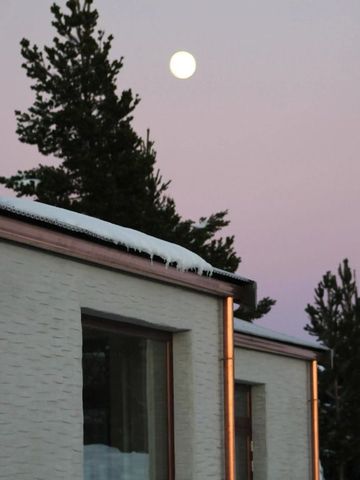 Fassade eines Gebäudes bei Vollmond und klarer Dämmerung