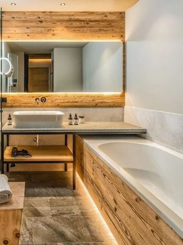 Modernes Badezimmer mit Holzverkleidung und großer Badewanne