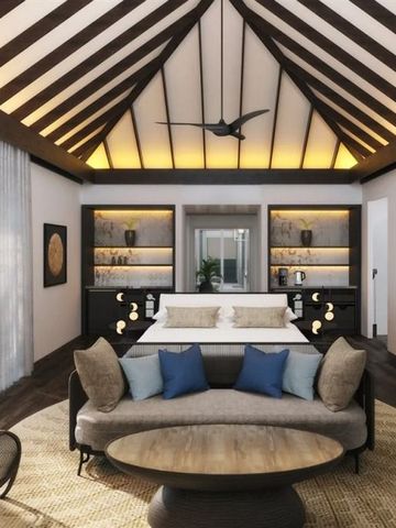 Schlafzimmer in Villa mit Holzbalkendecke und eleganter Einrichtung