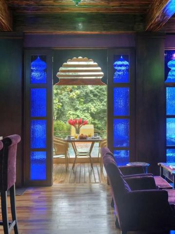 Eleganter Barbereich mit blauen Glasfenstern und gemütlichen Sitzgelegenheiten