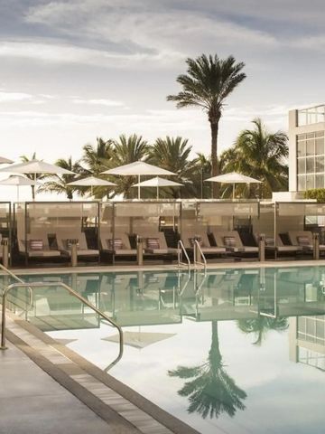 Moderner Poolbereich mit Liegestühlen Palmen und Sonnenschirmen