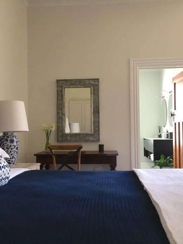 Gemütliches Hotelzimmer mit dunkelblauem Bettbezug und eleganter Dekoration