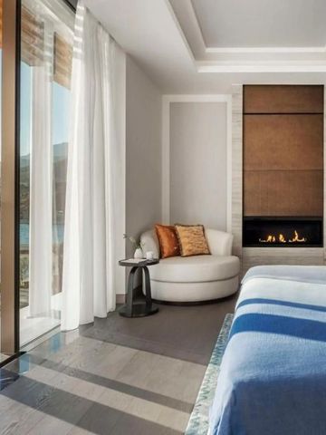 Gemütliches Zimmer mit Kamin und Blick aufs Wasser.