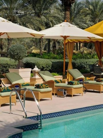 Einladender Pool mit Sonnenschirmen und bequemen Liegen im One&Only Royal Mirage