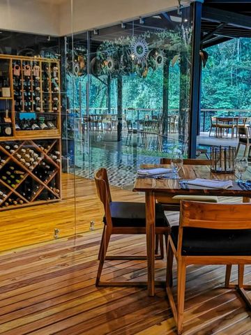 Restaurantbereich mit Weinkeller und Blick in den Wald