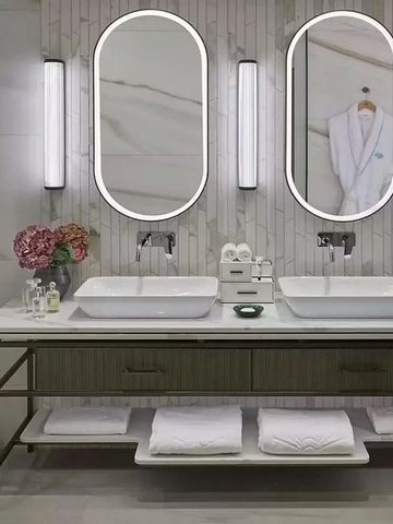 Doppelwaschbecken mit großem Spiegel und stilvollen Leuchten