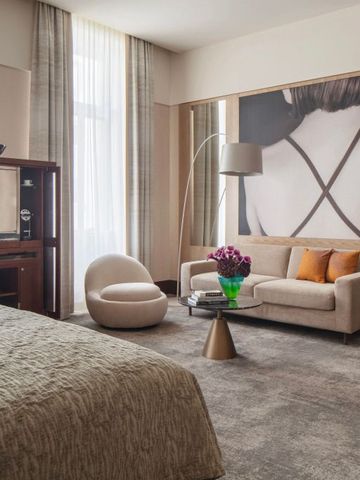 Einladendes Hotelzimmer mit stilvollem Sofa und Kunst an der Wand