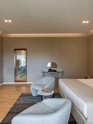 Großzügiges Zimmer mit minimalistischer Einrichtung und warmem Beleuchtungskonzept