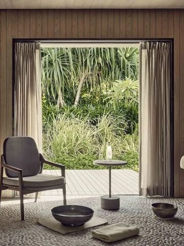 Eleganter Raum mit offener Sicht auf grünen Garten durch große Fenster.