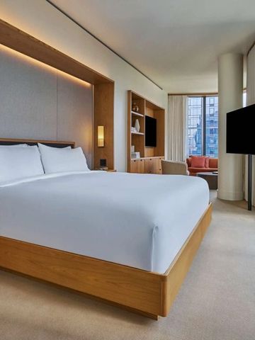 Geräumiges Zimmer mit großen Fenstern und gemütlichem Sitzbereich