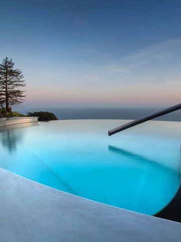 Infinity-Pool bei Dämmerung, umgeben von Natur