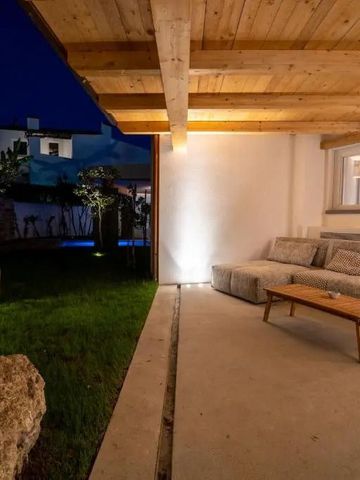 Gemütliche Terrasse bei Nacht mit Sofaecke und Beleuchtung