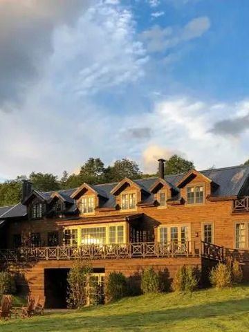 Großzügige Holzlodge in sonnendurchfluteter Landschaft