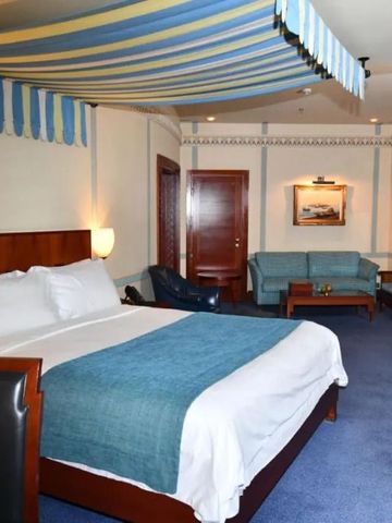 Großzügiges Zimmer mit eleganter Einrichtung und gemütlicher Sitzecke