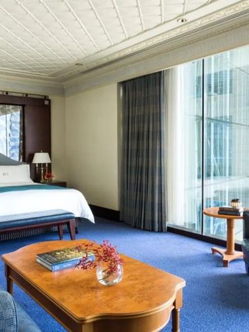 Zimmer mit eleganter Möblierung und beeindruckenden Glasfenstern.