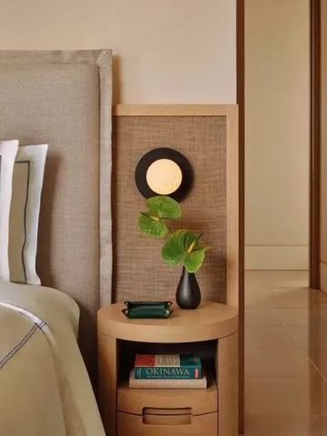 Nachttisch mit Lampe und Dekoration im Hotelzimmer