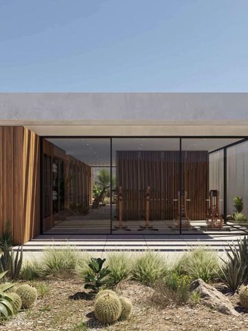 Moderne Architektur mit Glasfront und begrüntem Außenbereich.