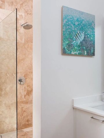 Elegante Dusche mit Glaswand und modernem Kunstwerk im Badezimmer