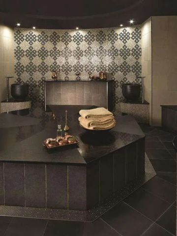 Luxuriöses Spa mit stimmungsvoller Beleuchtung und eleganten Fliesenmustern