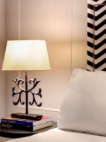 Schlafzimmer mit stilvoller Lampe und dekorativem Kopfteil