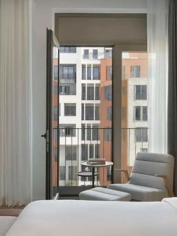 Zimmer mit Balkon und Blick auf moderne Architektur