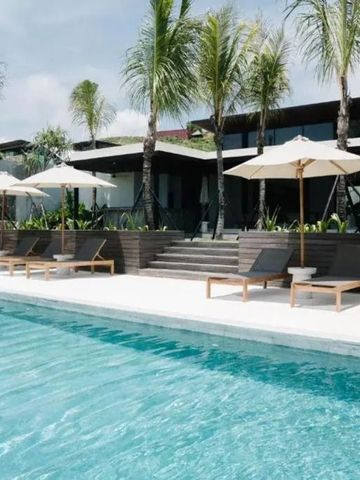 Moderner Poolbereich mit Liegestühlen und Palmen